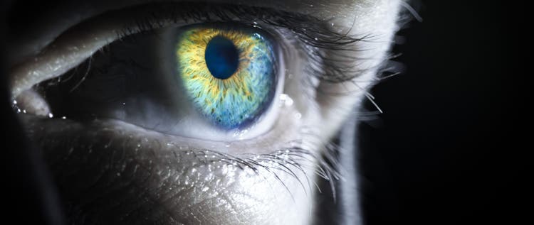 A mesmerizing closeup photo of a human eye with brilliant colors and futuristic lighting, revealing depth and emotion