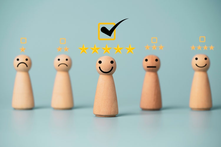 Wooden figure smiley with golden stars and correct mark , Customer evaluation and satisfaction concept.