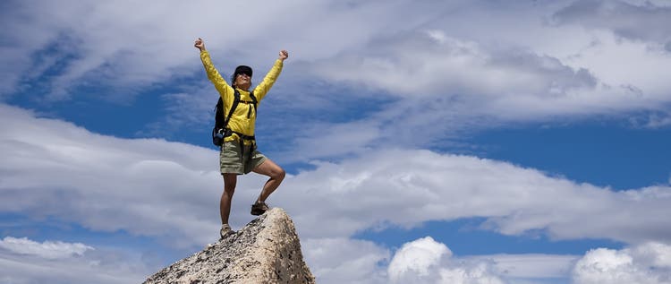 Hiker celebrates on the summit.