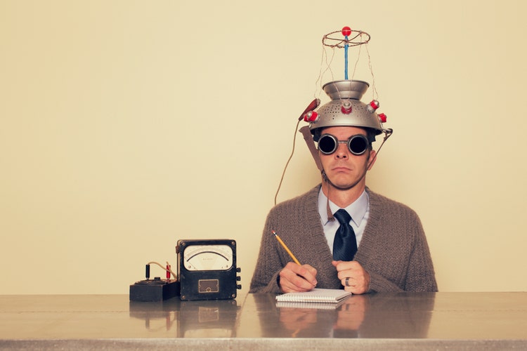 Man testing his brain with scientific helmet..