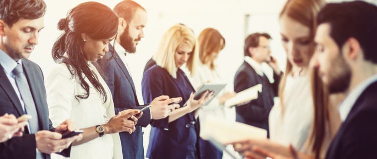 group of business people looking at phones