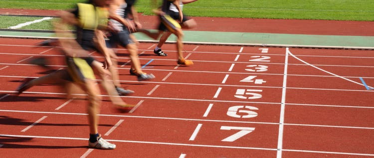 Runners racing on a numbered track