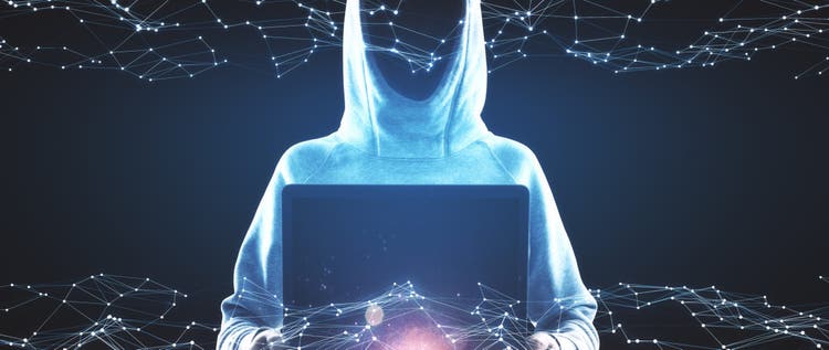 Hacker in hoodie using laptop with glowing polygonal hologram on dark background. Innovation, ai and hacking concept. Multiexposure