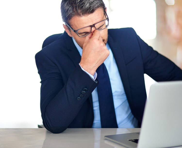 exhausted professional at computer