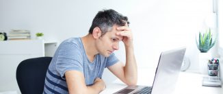 worried man at laptop