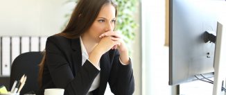 woman looks at computer