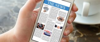 Woman hand holding smart phone displaying the news in a coffee shop.