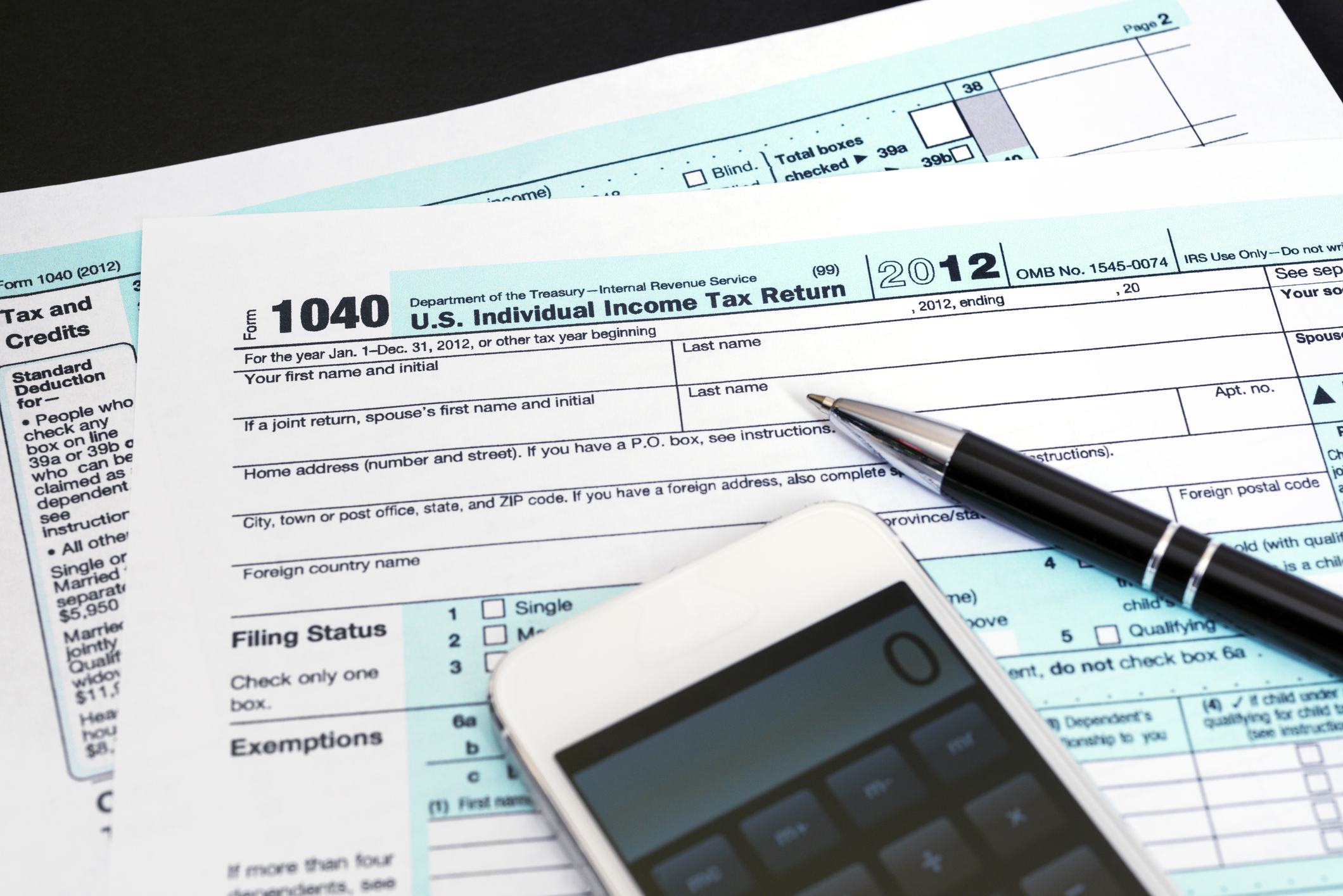 1040 tax forms with a phone and pen