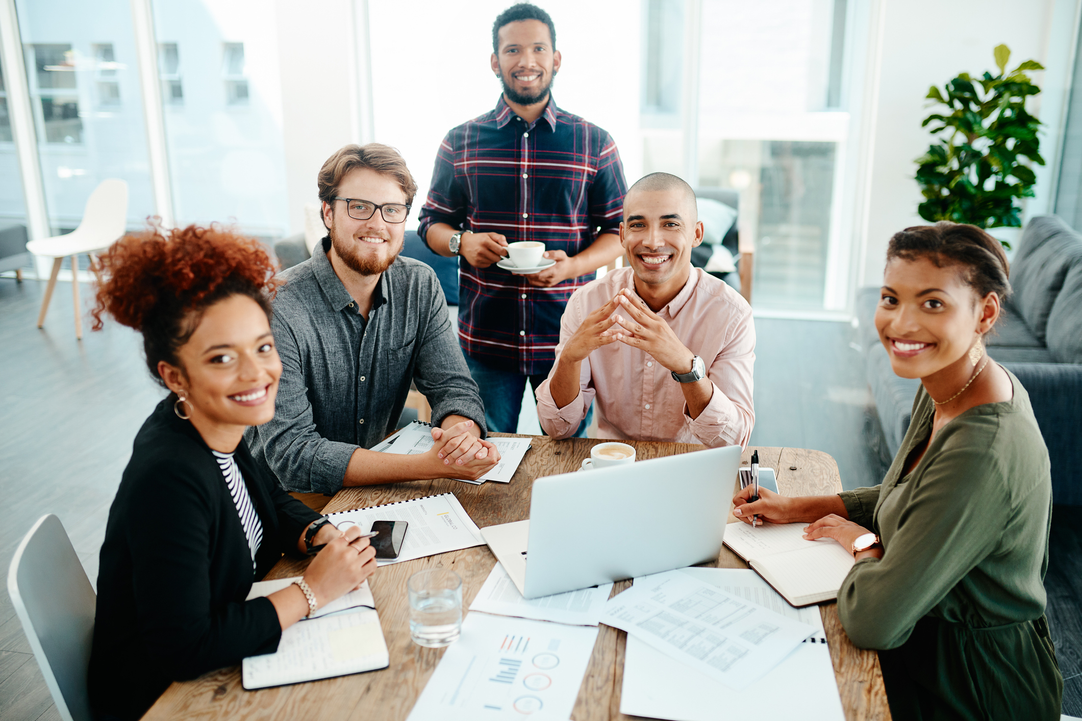 Portrait of a group of young businesspeople discussing ideas during a meeting at work