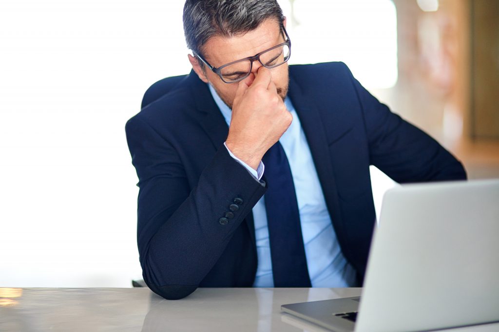 exhausted professional at computer