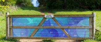 Green field with wooden gate across a path. The space between the fence boards is shaded blue and contains computer code in white