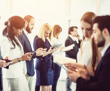 group of business people looking at phones