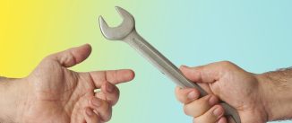 A man's hand giving another man's hand a wrench against a yellow and blue background.