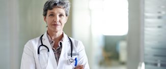 Portrait of a mature female doctor standing in a hospital corridor