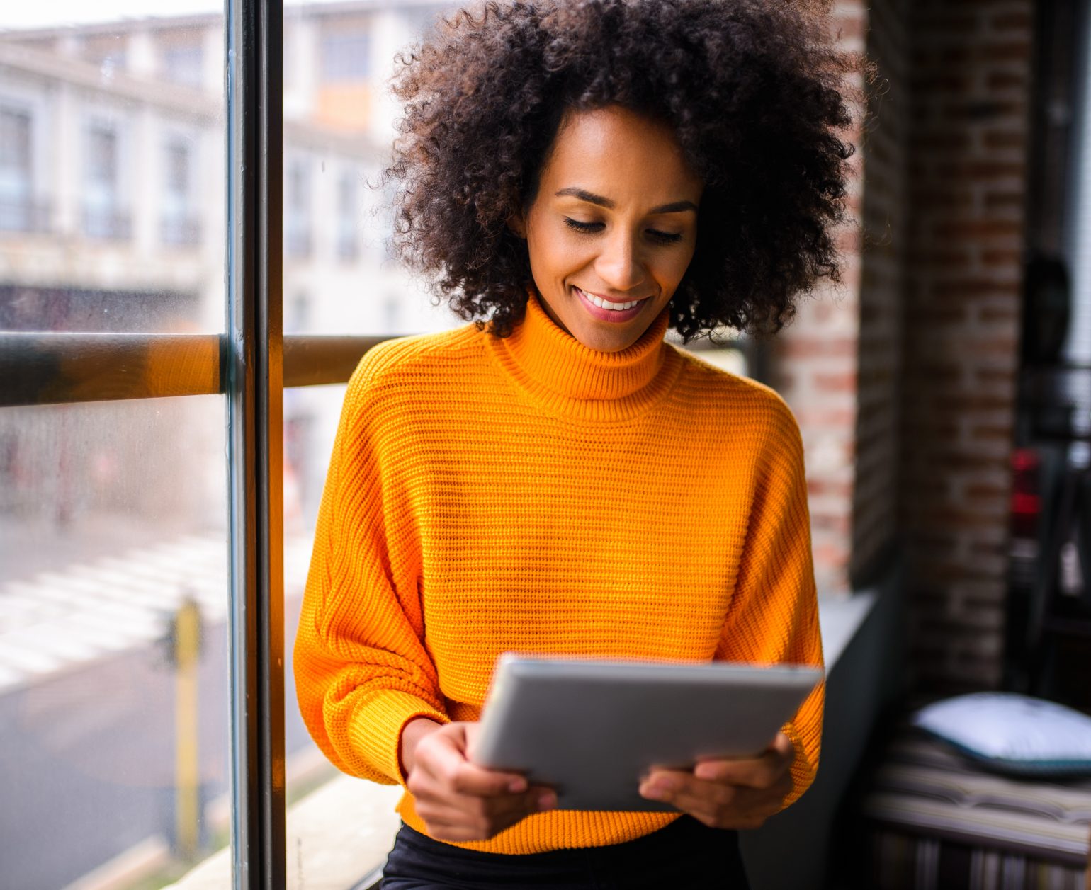 Smiling woman using digital tablet.