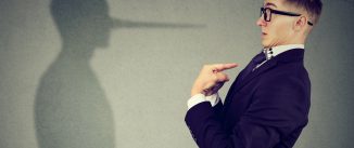 Man pointing at himself while lying
