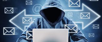 man on a computer surrounded by email icons