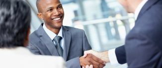Angled view of a very happy African-American businessman shaking hands
