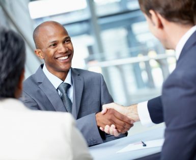 Angled view of a very happy African-American businessman shaking hands