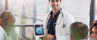 Male doctor showing a brain scan to colleagues.