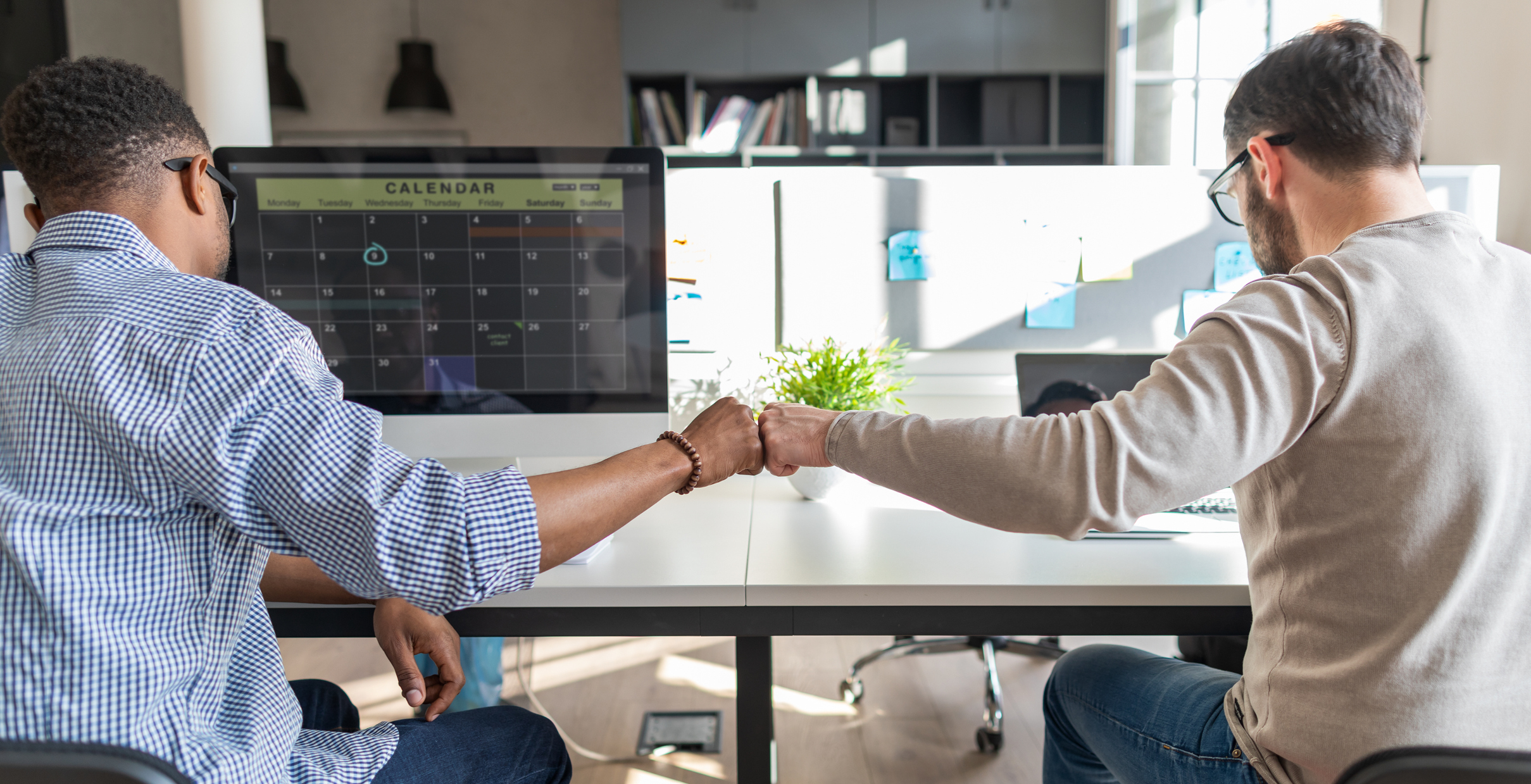 First bump between colleagues at work. Success in business. Everyday work in the office.