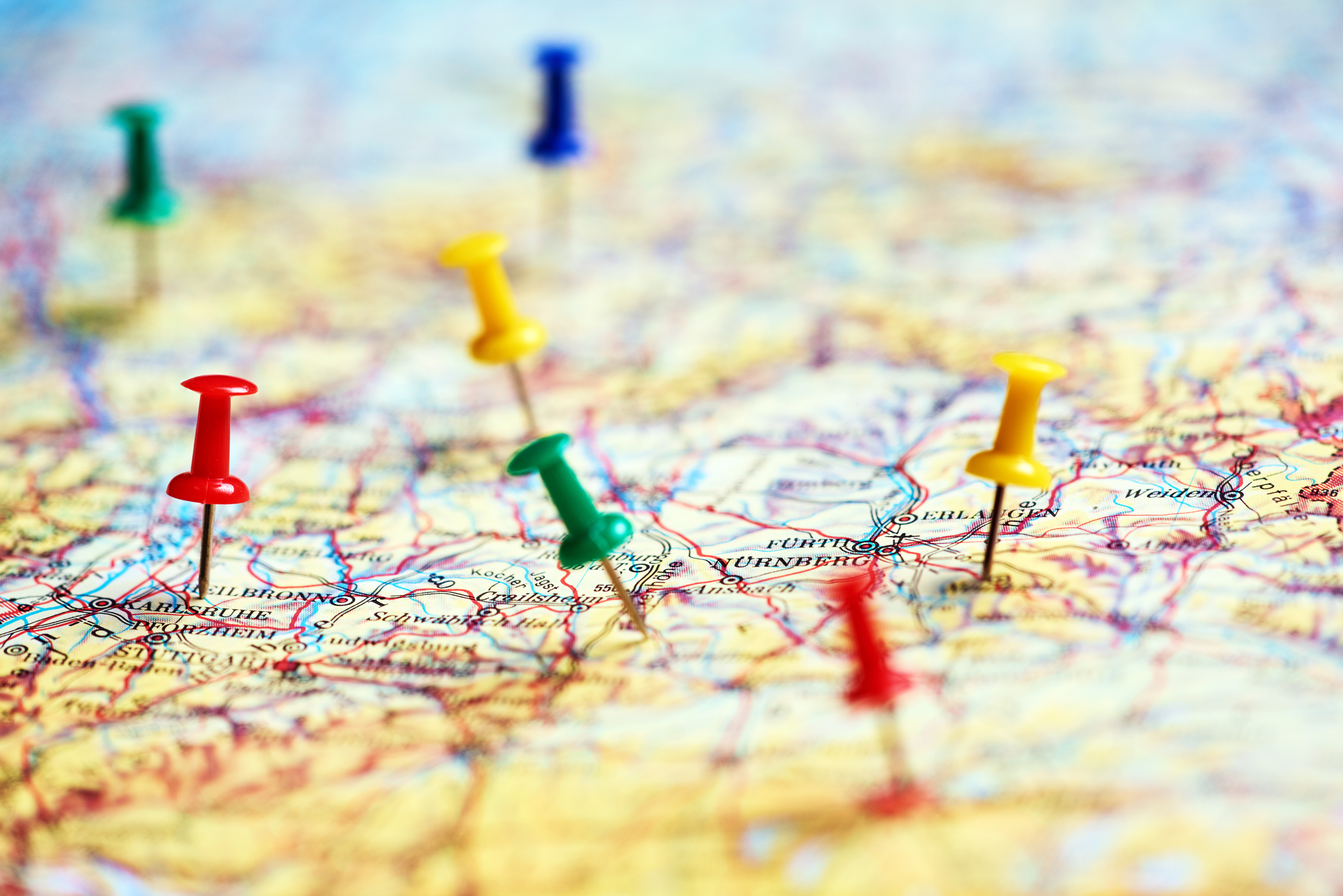 horizontal shot of colorful pins marking different destinations in Europe.