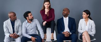 how to write a resume background Studio shot of a group of corporate businesspeople waiting in line against a gray background