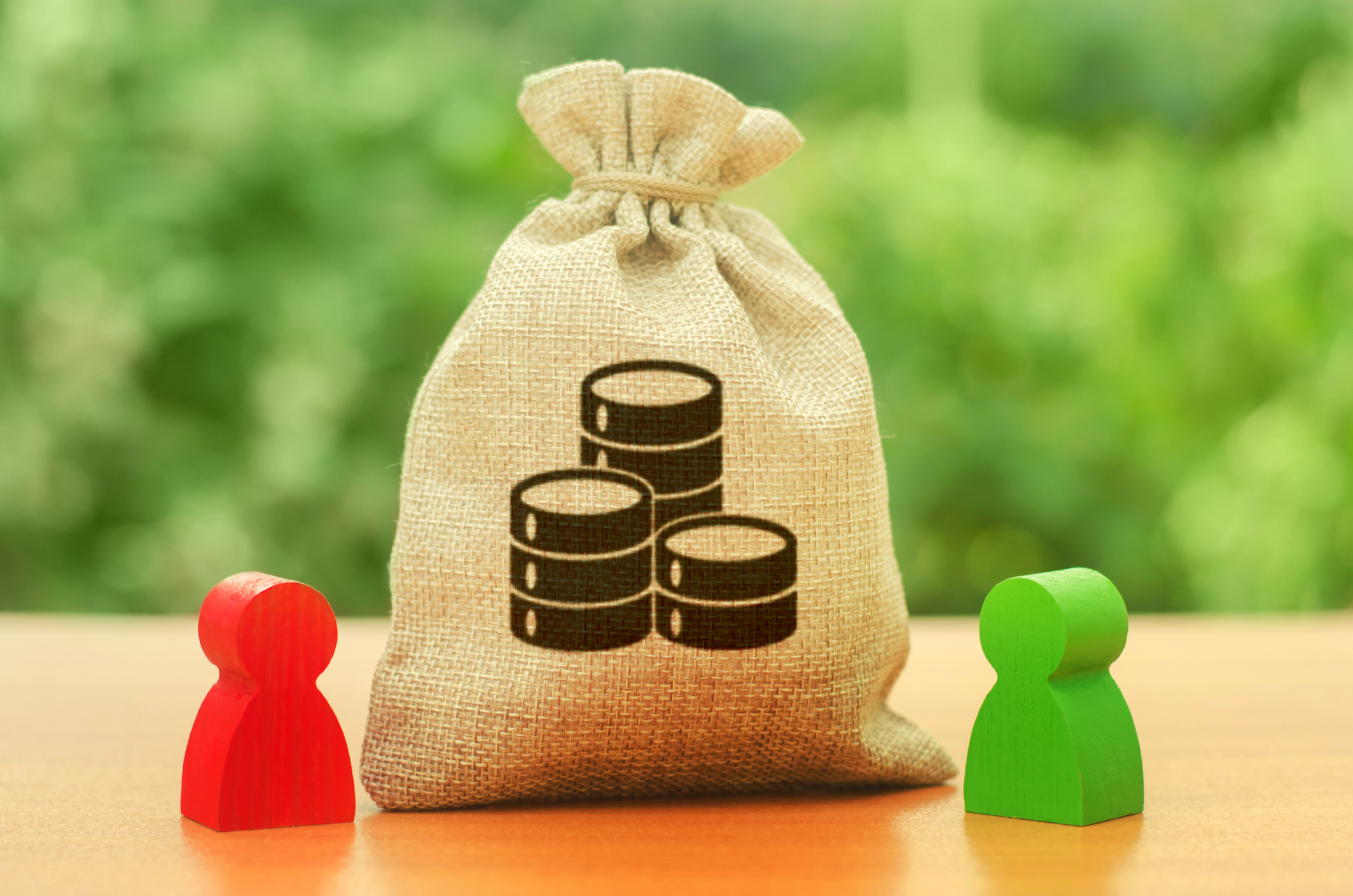 Money bag with money coins symbol and two people figures. Division of resources