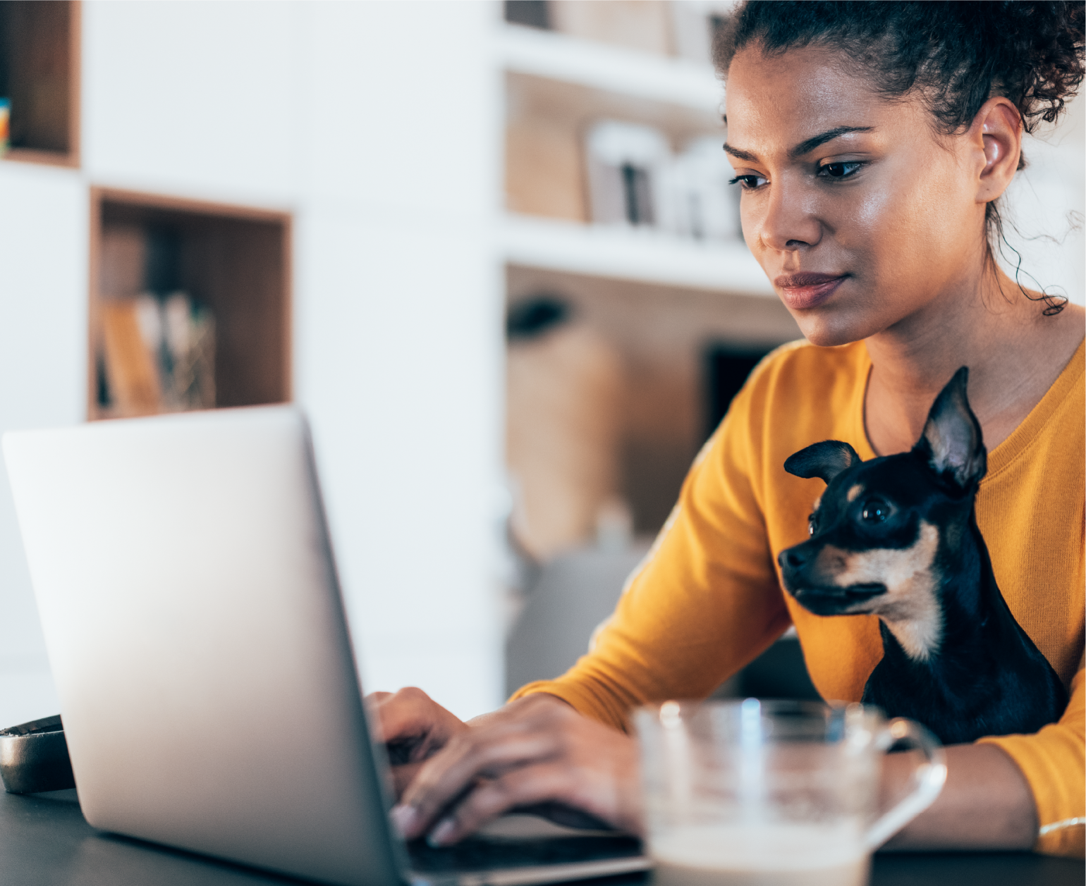 woman at laptop with dog