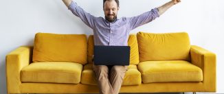 Young adult businessman working with laptop at the office