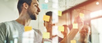 Cropped shot of a group of young designers using sticky notes during a brainstorming session