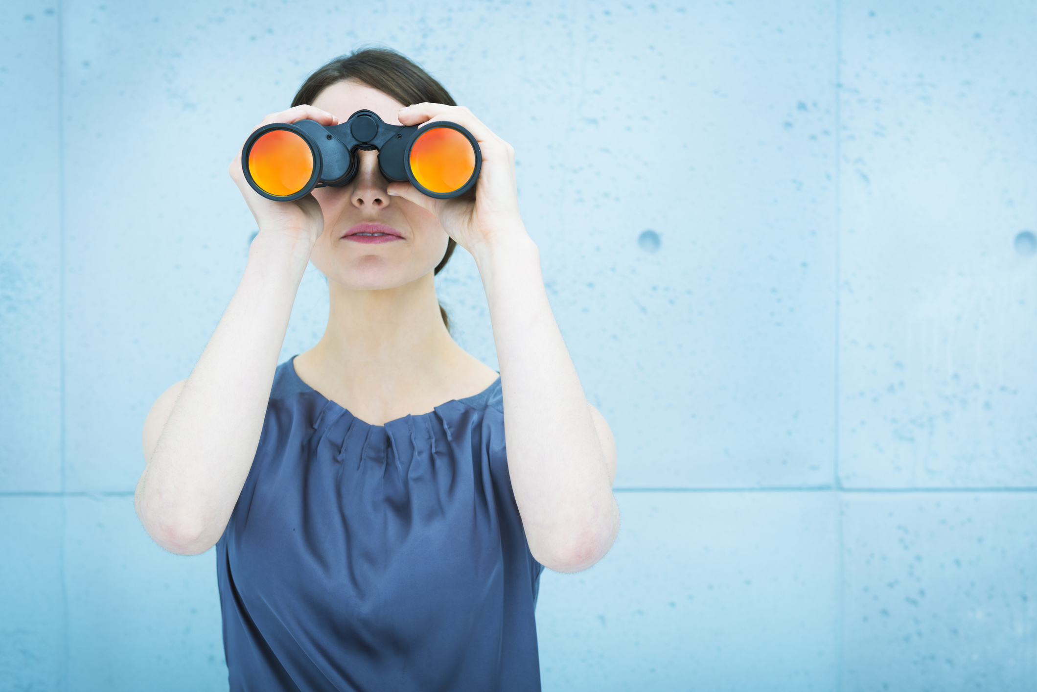 Business vision: woman holding binoculars