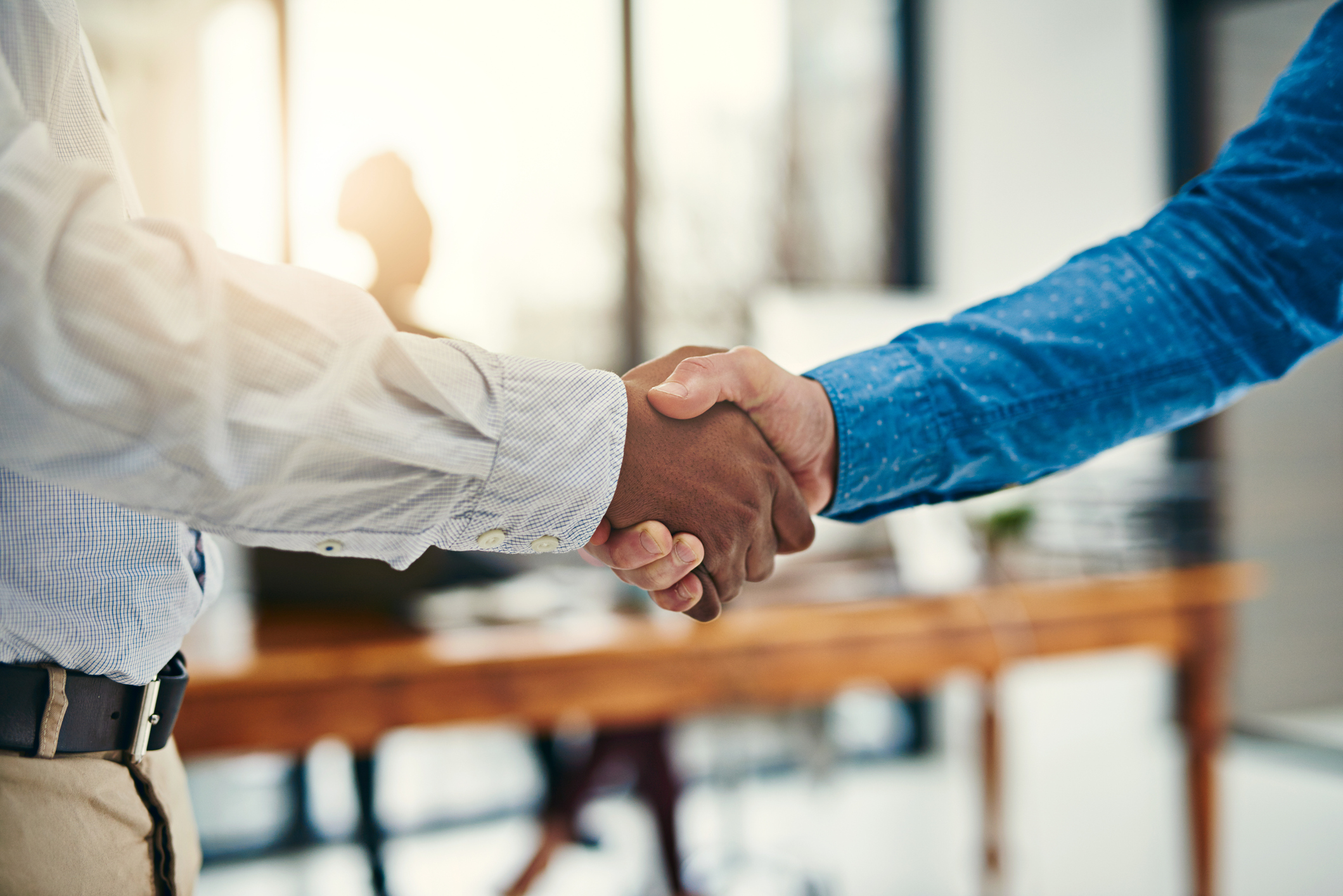 Closeup shot of businesspeople shaking hands in an office