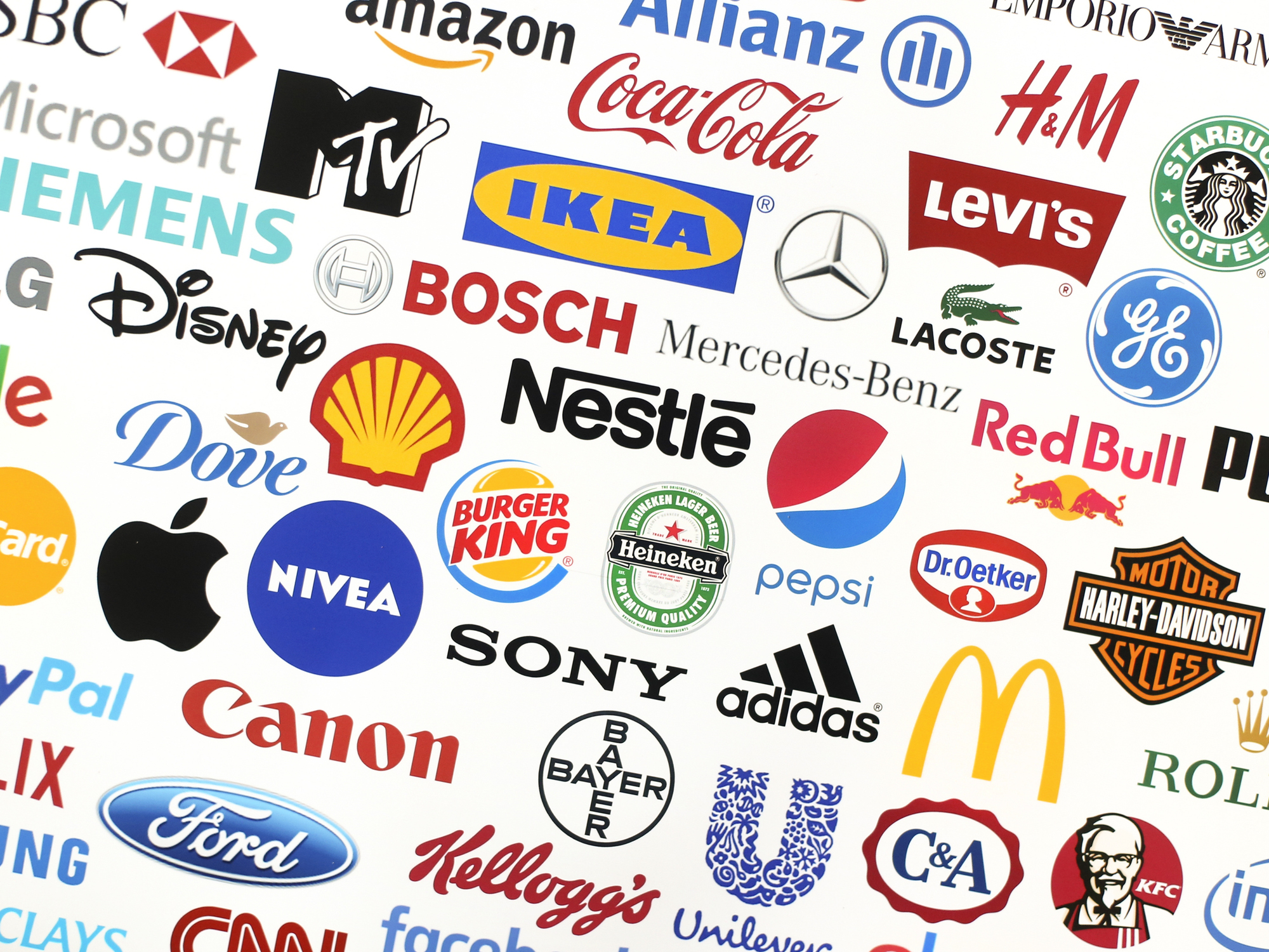 Logotype collection of some of most famous brands in the world on a screen - including Adidas, Nestle, Nike, McDonald's, Sony, Facebook, Ikea, Pepsi and much more printed on quality paper and shot with a high resolution camera.