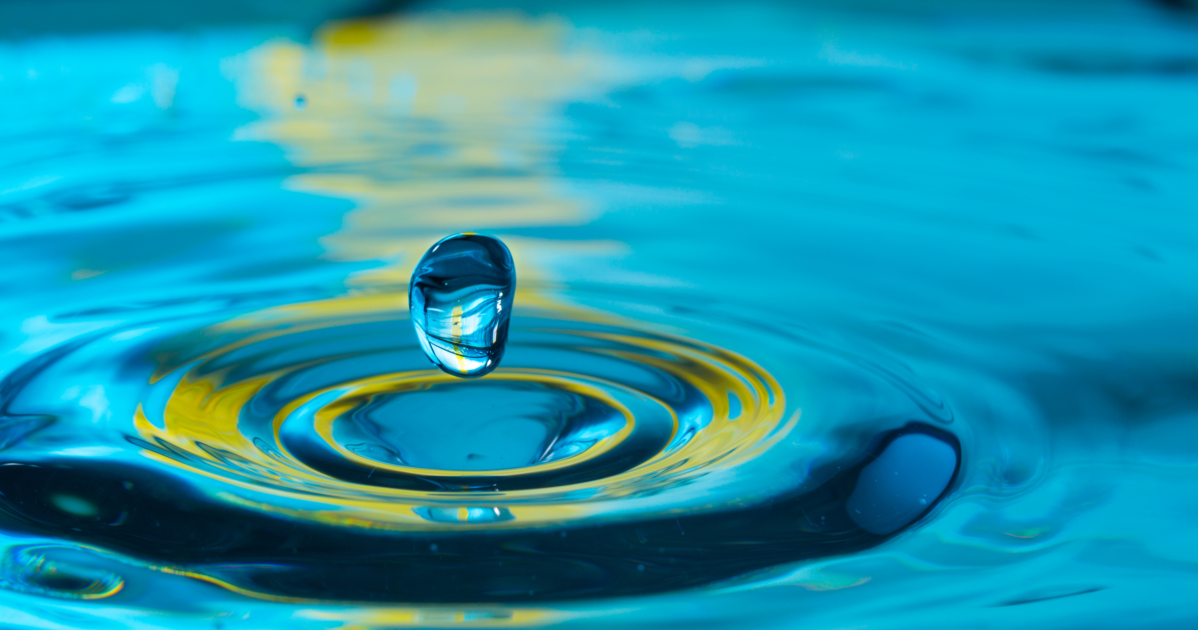 water drop splash in a glass blue colored