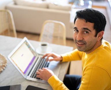 Portrait of a mid adult man using the laptop at home